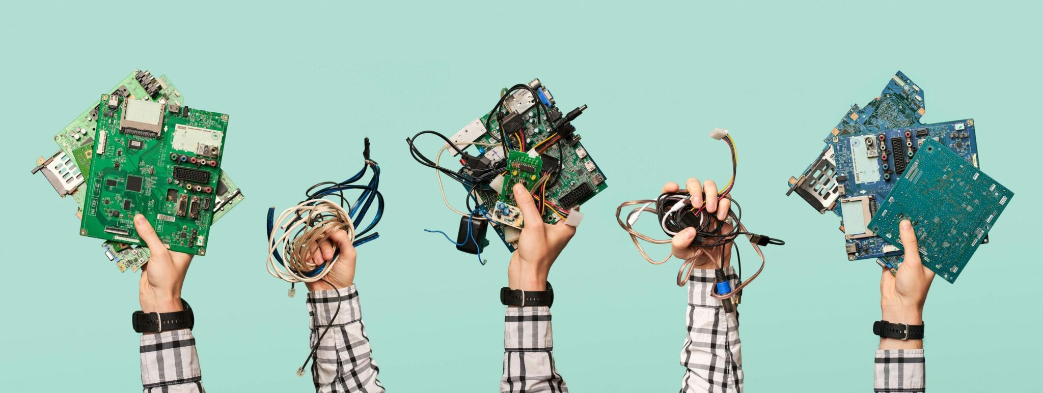 Hands holding electronic cords and circuit boards